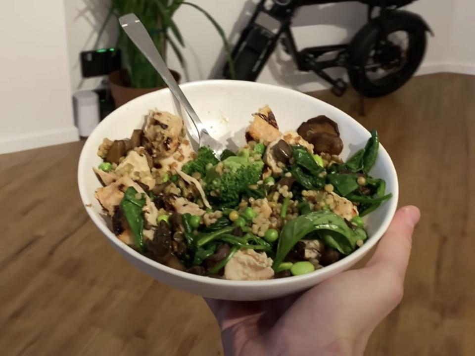 A bowl of chicken, lentils, and vegetables.