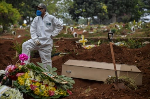 Employees carry the coffin of a person who died from COVID-19 at the Vila Formosa cemetery, in the outskirts of Sao Paulo, Brazil on May 20, 2020