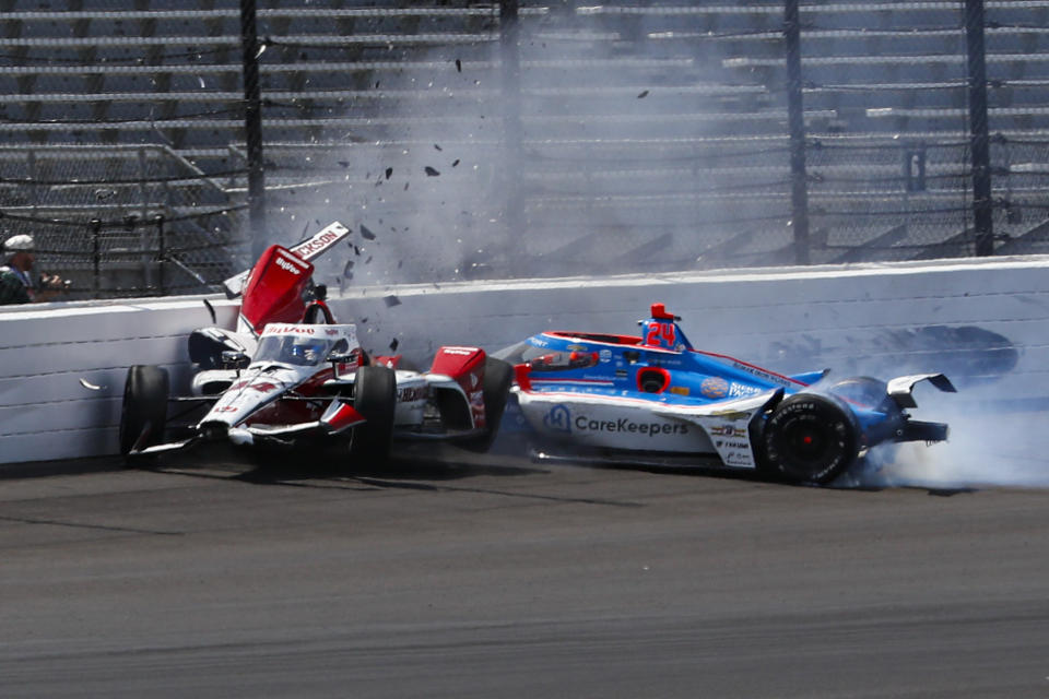 Katherine Legge, of England, left, and Stefan Wilson, of England, crash in the first turn during practice for the Indianapolis 500 auto race at Indianapolis Motor Speedway in Indianapolis, Tuesday, May 23, 2023. (AP Photo/Kirk DeBrunner)