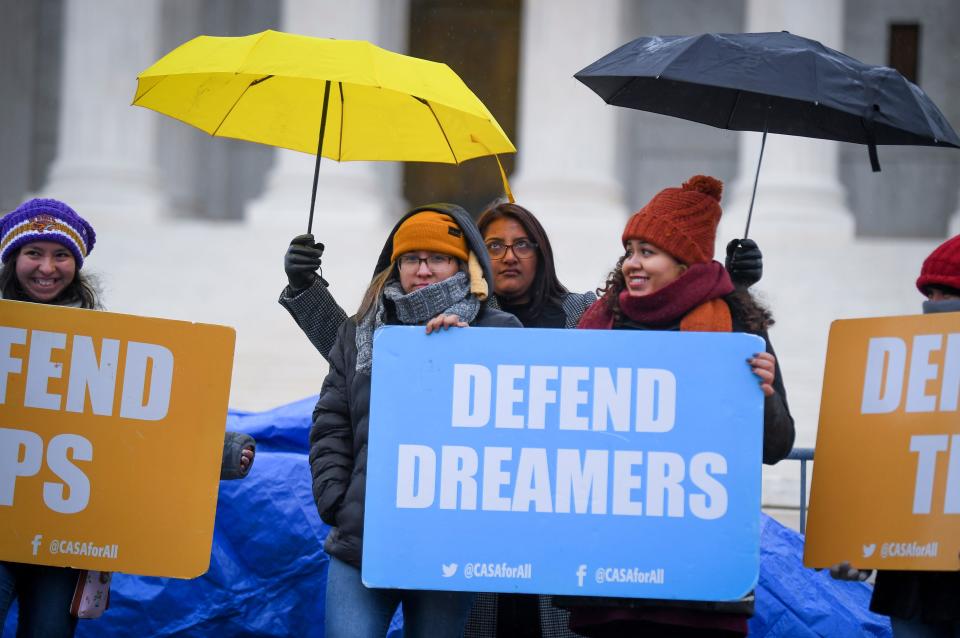 People stand in the cold and rain outside the U.S. Supreme Court on Nov. 12 before arguments on whether the Trump administration's decision to end the Deferred Action for Childhood Arrivals program (DACA) is lawful.