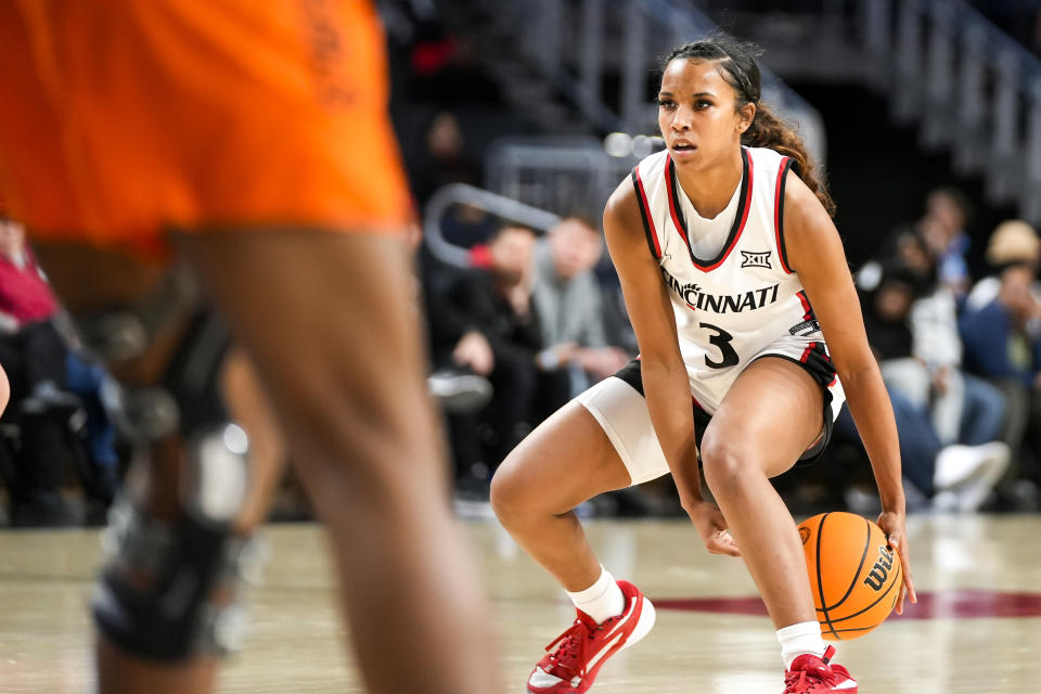 Cincinnati Bearcats guard Reagan Jackson (3) dribbles the ball between her legs during the second half of the NCAA women’s basketball game between the Cincinnati Bearcats and Oklahoma State Cowgirls on Wednesday, Jan. 24, 2024, at Fifth Third Arena in Cincinnati. Cincinnati won 58-56 in the last few seconds.