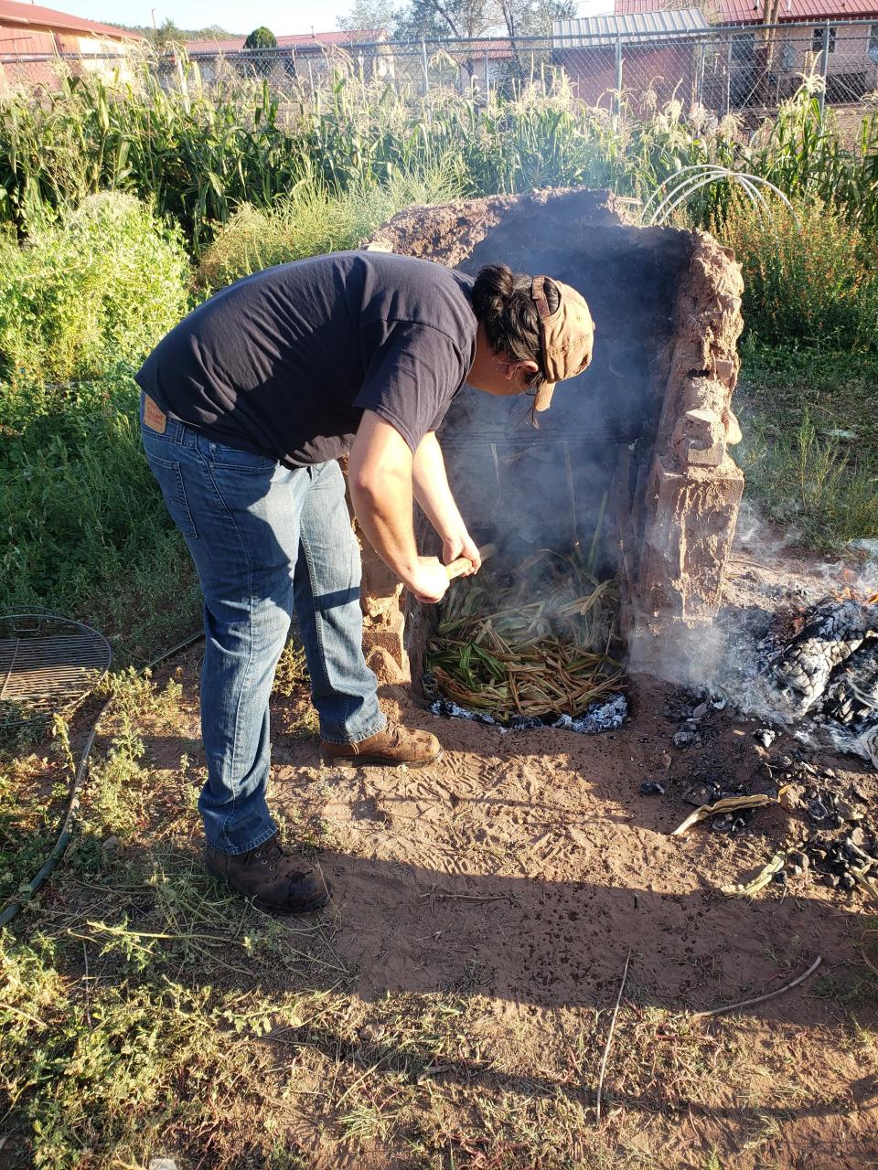 Steaming corn underground is a late summer and fall tradition for many Diné families.