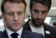 French President Emmanuel Macron and Tony Estanguet, president of the Paris 2024 Olympics Organising Committee, attend the inauguration of the Olympic Aquatics Center (CAO) in Saint-Denis, near Paris, Thursday, April 4, 2024. The aquatic center will host the artistic swimming, water polo and diving events during the Paris 2024 Olympic Games. (Gonzalo Fuentes/Pool via AP)