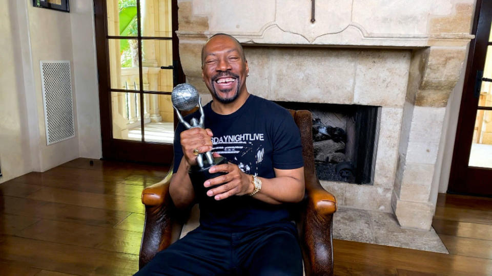 closeup of eddie holding an award