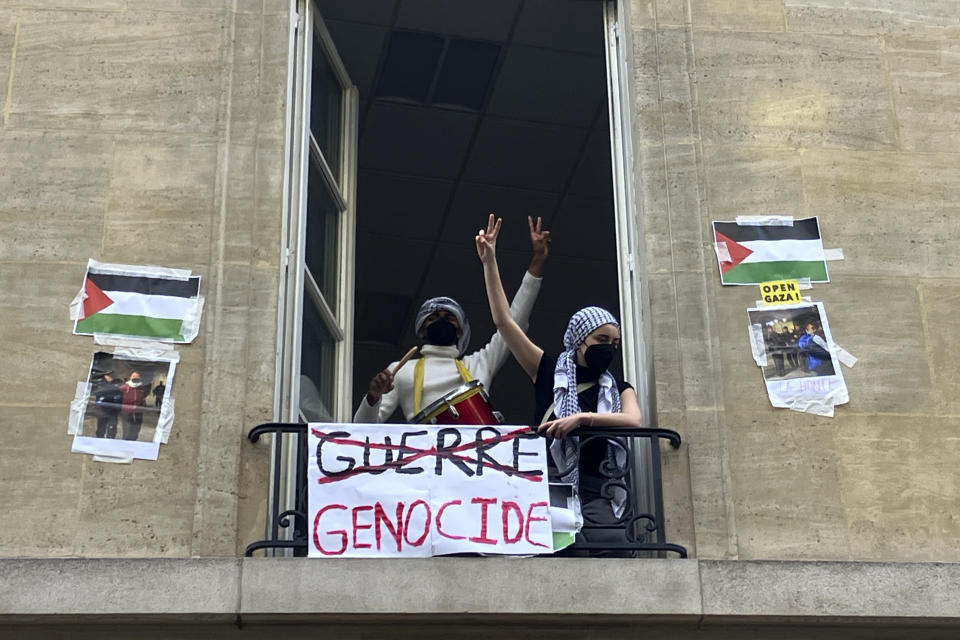 Students blocking the Sciences-Po university flash the V sign Friday, April 26, 2024 in Paris. Students at a prestigious university resumed pro-Palestinian protests on Friday, days after French police broke up a demonstration, inspired by Gaza solidarity encampments at campuses around the United States. Dozens of students the Sciences-Po university blocked an entrance to a campus building in central Paris with chairs and bikes. (AP Photo/Jeffrey Schaeffer)