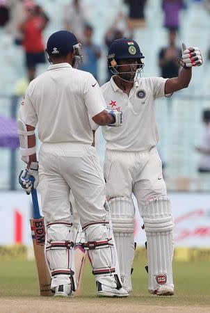 Cricket - India v New Zealand - Second Test cricket match - Eden Gardens, Kolkata - 01/10/2016. India's Wriddhiman Saha (R) celebrates after scoring his half century. REUTERS/Rupak De Chowdhuri