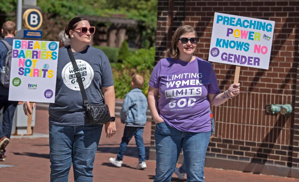 Heather Deal, left, and Nikki Hardeman, with the Baptist Women in Ministry, protest on June 11 for the right for women to be clergy, while standing outside the Southern Baptist Convention's annual meeting in Indianapolis, Indiana.