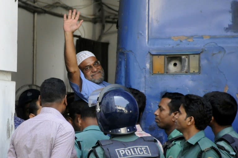 Then Bangladeshi Jamaat-e-Islami party leader, Mir Quasem Ali, waves outside the International Crimes Tribunal court in Dhaka, in 2014