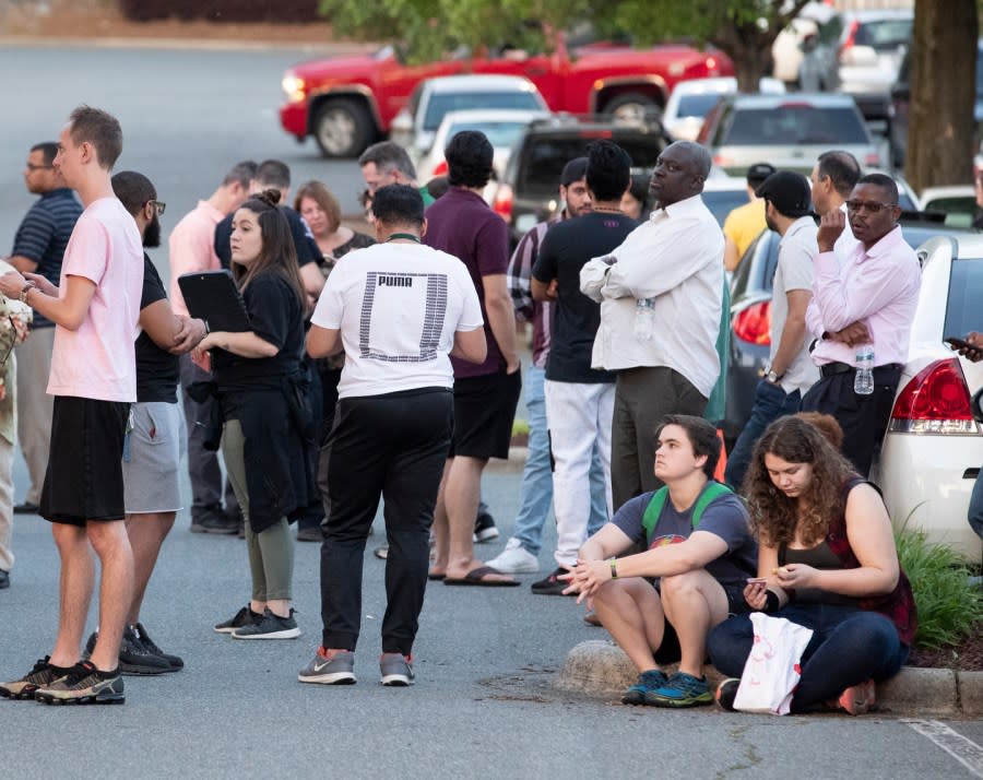 People gather across from the campus of UNC Charlotte after a shooting incident at the school Tuesday, April 30, 2019, in Charlotte, N.C. (AP Photo/Jason E. Miczek)