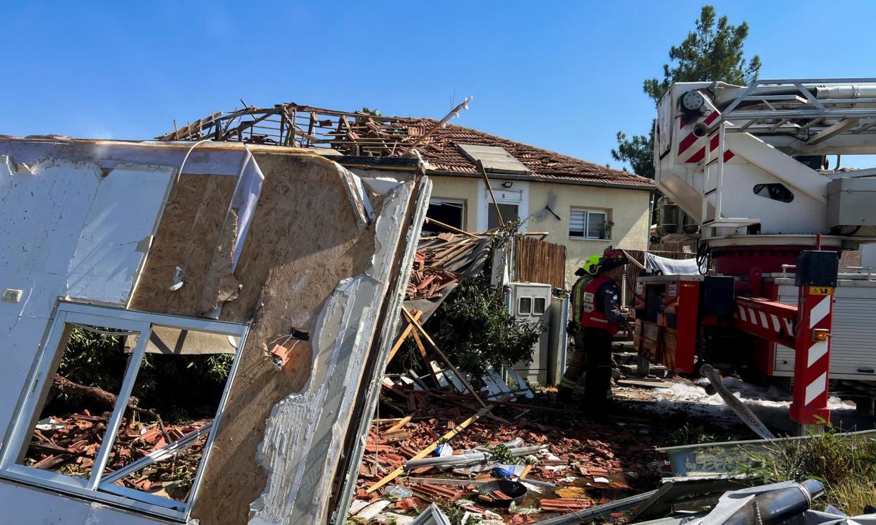 <span>Firefighters work at the site of a house in the Israeli-occupied Golan Heights that was damaged after rockets were fired from Lebanon.</span><span>Photograph: Avi Ohayon/Reuters</span>