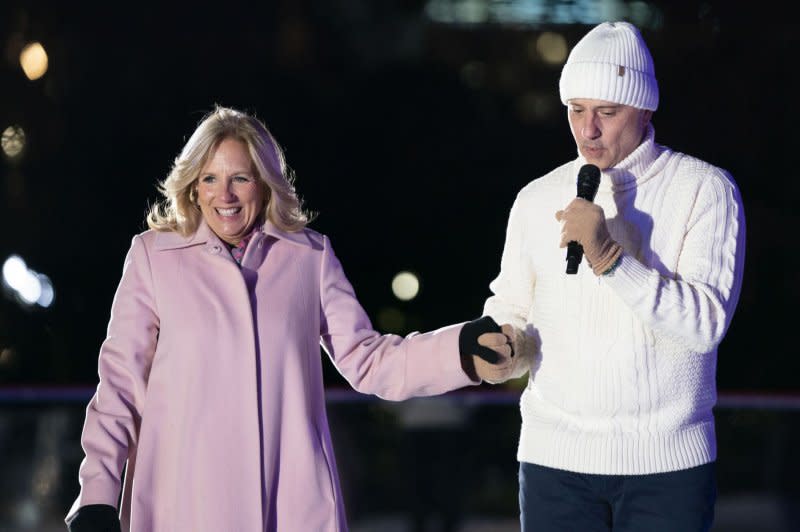 U.S. Olympic and World Champion Brian Boitano speaks as first lady Jill Biden smiles during Wednesday's unveiling of the White House Holiday Ice Rink on the South Lawn of the White House in Washington, D.C. Photo by Bonnie Cash/UPI