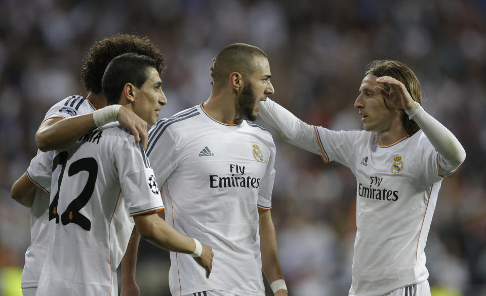 Real's Karim Benzema, center, celebrates scoring the opening goal during a Champions League semifinal first leg soccer match between Real Madrid and Bayern Munich at the Santiago Bernabeu stadium in Madrid, Spain, Wednesday, April 23, 2014 .(AP Photo/Paul White)