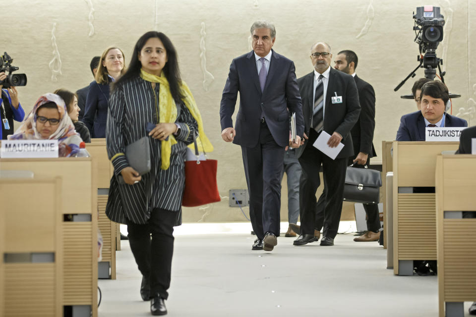 Pakistan's Foreign Minister Shah Mehmood Qureshi, center, arrives for a statement during the 42nd session of the Human Rights Council at the European headquarters of the United Nations in Geneva, Switzerland, Tuesday, Sept. 10, 2019. (Salvatore Di Nolfi/Keystone via AP)