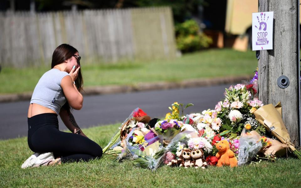 Korri Loader, a friend of the victims, grieves at a makeshift memorial - Dan Peled/AAP Image via AP