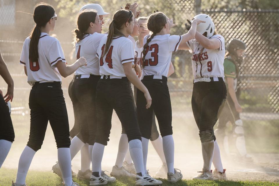 Hudson softball players celebrate a run during Monday's win over Clinton.