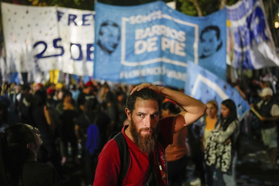 A supporter of Argentina's Economy Minister Sergio Massa holds his head after the presidential candidate of the ruling party conceded defeat to opposition candidate Javier Milei in the presidential runoff election in Buenos Aires, Argentina, Sunday, Nov. 19, 2023. (AP Photo/Matias Delacroix