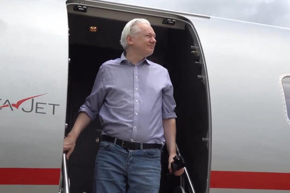 Assange arriving in Bangkok en route to the Mariana Islands (PA Wire)