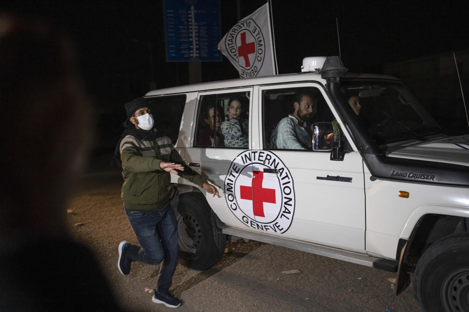 A Red Cross vehicle carrying Israeli hostages drives by at the Gaza Strip crossing into Egypt in Rafah on Saturday, Nov. 25, 2023. (AP Photo/Fatima Shbair)