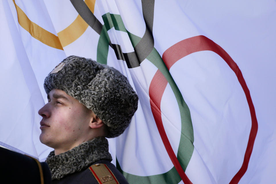 A member of Russian honor guard listens to the Olympic Anthem during a welcome ceremony for the German Olympic team at the Mountain Olympic Village prior to the 2014 Winter Olympics, Wednesday, Feb. 5, 2014, in Krasnaya Polyana, Russia. (AP Photo/Jae C. Hong)