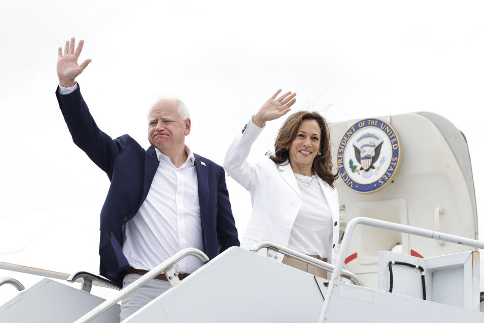 TOPSHOT - US Vice President and 2024 Democratic presidential candidate Kamala Harris and her running mate Minnesota Governor Tim Walz wave as they board Air Force Two, departing Chippewa Valley Regional Airport in Eau Claire, Wisconsinon, August 7, 2024. (Photo by KAMIL KRZACZYNSKI / AFP) (Photo by KAMIL KRZACZYNSKI/AFP via Getty Images)