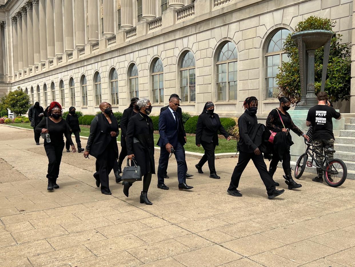 John Johnson (center), also known as Grandmaster Jay, walks into the Gene Snyder U.S. Courthouse and Customs House in downtown Louisville, Ky., on Tuesday, May 24, 2022. Johnson faced charges of assaulting and brandishing a firearm against federal officers during a protest surrounding the Breonna Taylor case in 2020.