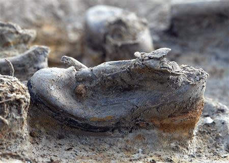 A pair of shoes, believed to belong to a British soldier, are seen after they were excavated from a World War I trench near the Belgian city of Ypres on the Western Front in this November 10, 2003 file photo. REUTERS/Thierry Roge/Files