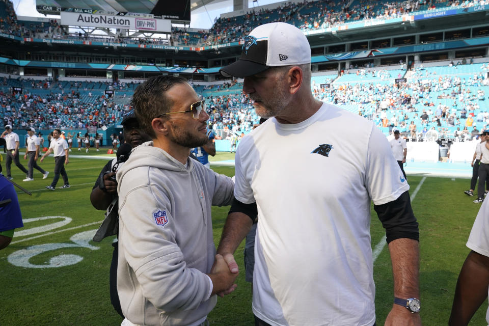 Miami Dolphins head coach Mike McDaniel and Carolina Panthers head coach Frank Reich shake hands at the end of an NFL football game, Sunday, Oct. 15, 2023, in Miami Gardens, Fla. The Dolphins defeated the Panthers 42-21. (AP Photo/Wilfredo Lee )