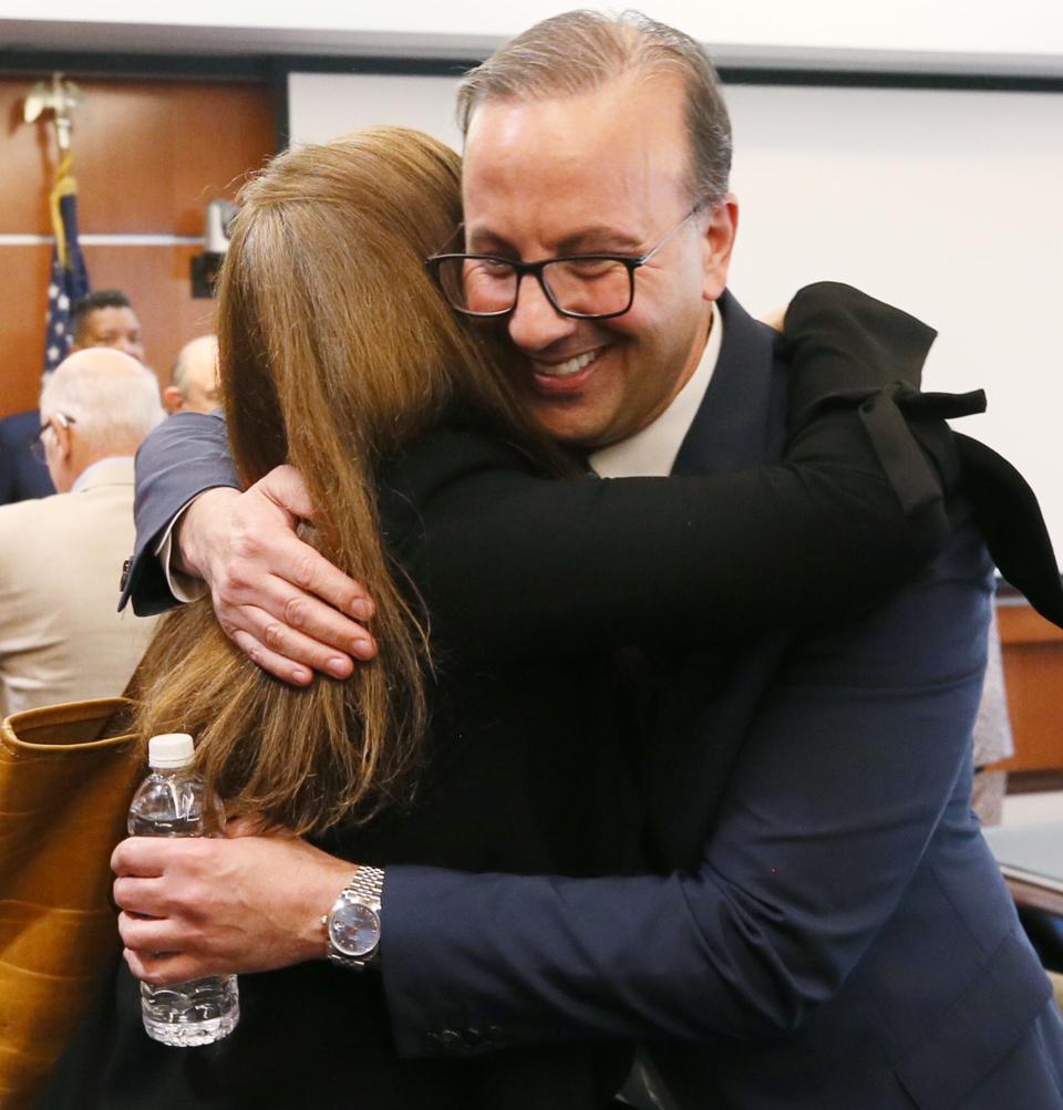 University of Akron trustee Christine Amer Mayer congratulates business college Dean R.J. Nemer after he is named the new University of Akron president.