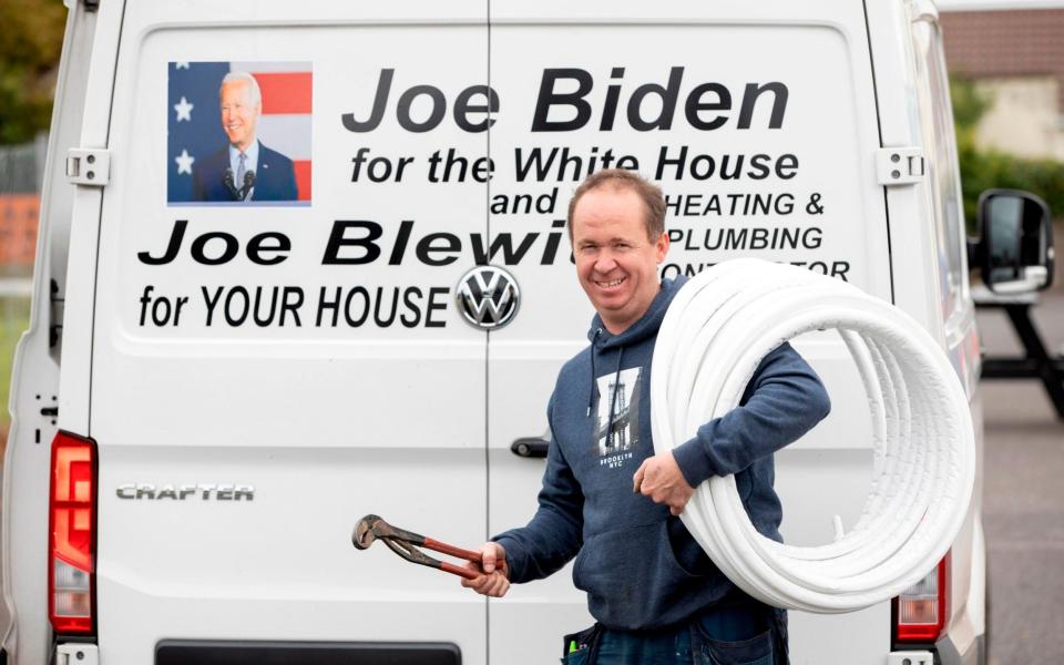 Joe Blewitt (C), a cousin of US Presidential candidate Joe Biden, poses for a photograph in Biden's ancestral home of Ballina, north west Ireland, on October 7, 2020 -  AFP