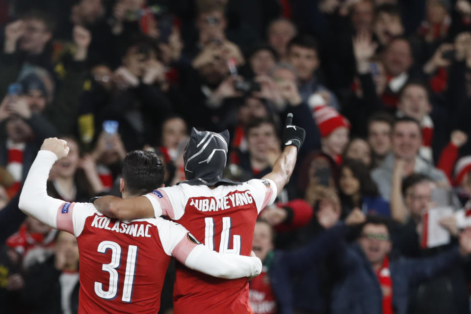 Arsenal's Pierre-Emerick Aubameyang, right, celebrates after scoring his side's third goal during the Europa League round of 16, 2nd leg, soccer match between Arsenal and Rennes at the Emirates stadium in London, Thursday, March 14, 2019. (AP Photo/Alastair Grant)