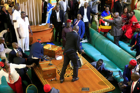 Ugandan opposition lawmakers fight with plain-clothes security personnel in the parliament while protesting a proposed age limit amendment bill debate to change the constitution for the extension of the president's rule, in Kampala, Uganda September 27, 2017. REUTERS/James Akena