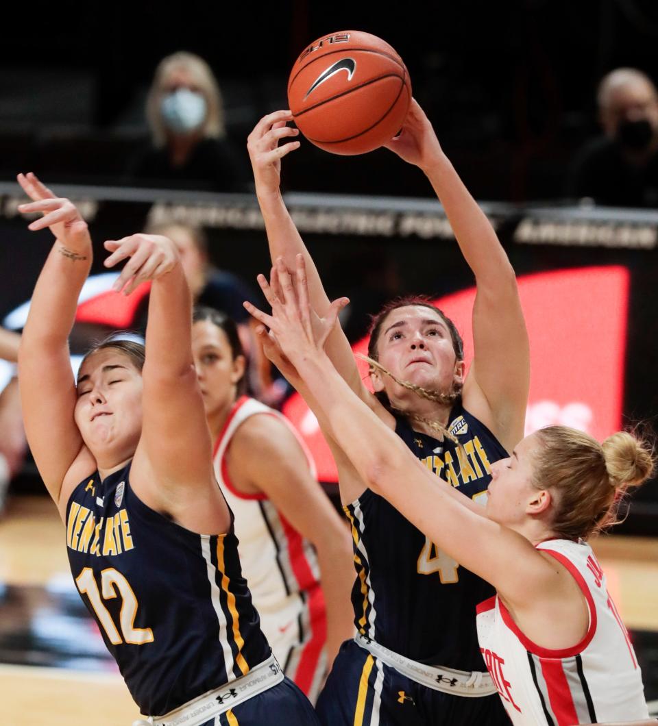 Kent State Golden Flashes guard Katie Shumate (14) pulls down a rebound over Ohio State Buckeyes forward Dorka Juhasz (14) and Kent State Golden Flashes center Linsey Marchese (12) during the first quarter of a NCAA Division I women's basketball game between the Ohio State Buckeyes and the Kent State Golden Flashes on Wednesday, Dec. 2, 2020 at the Covelli Center in Columbus, Ohio. 