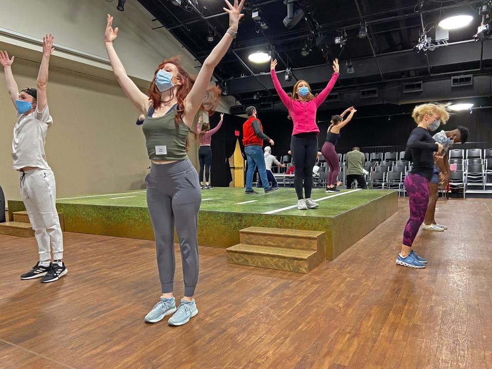 John Riesen, red jacket, center, rehearses with the “Favorite Son” ensemble composed of Belmont University music theater students.