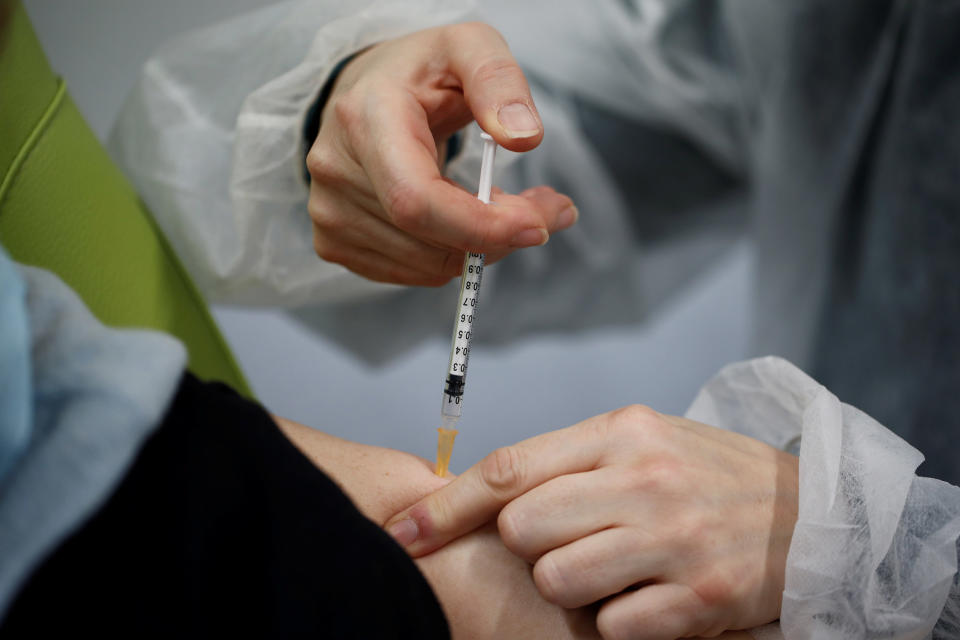 Image: An elderly person receives a dose of the Pfizer-BioNTech Covid-19 vaccine in Lamballe-Armor, France. (Benoit Tessier / Reuters)