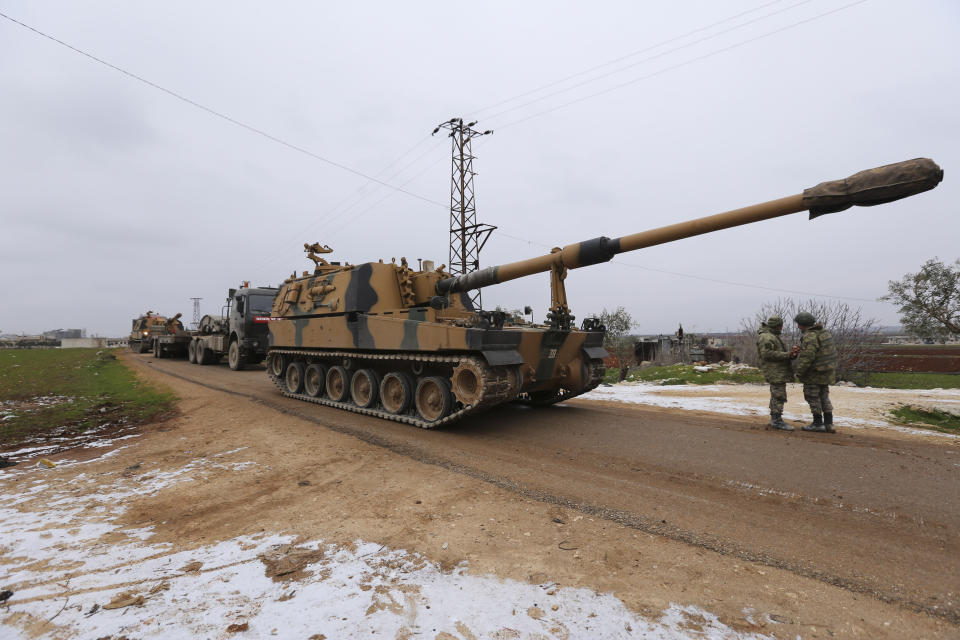 Turkish military convoy is seen near the town of Idlib, Syria, Wednesday, Feb. 12, 2020. Turkish President Recep Tayyip Erdogan said Wednesday that Turkey will attack government forces anywhere in Syria if another Turkish soldier is injured. (AP Photo/Ghaith Alsayed)