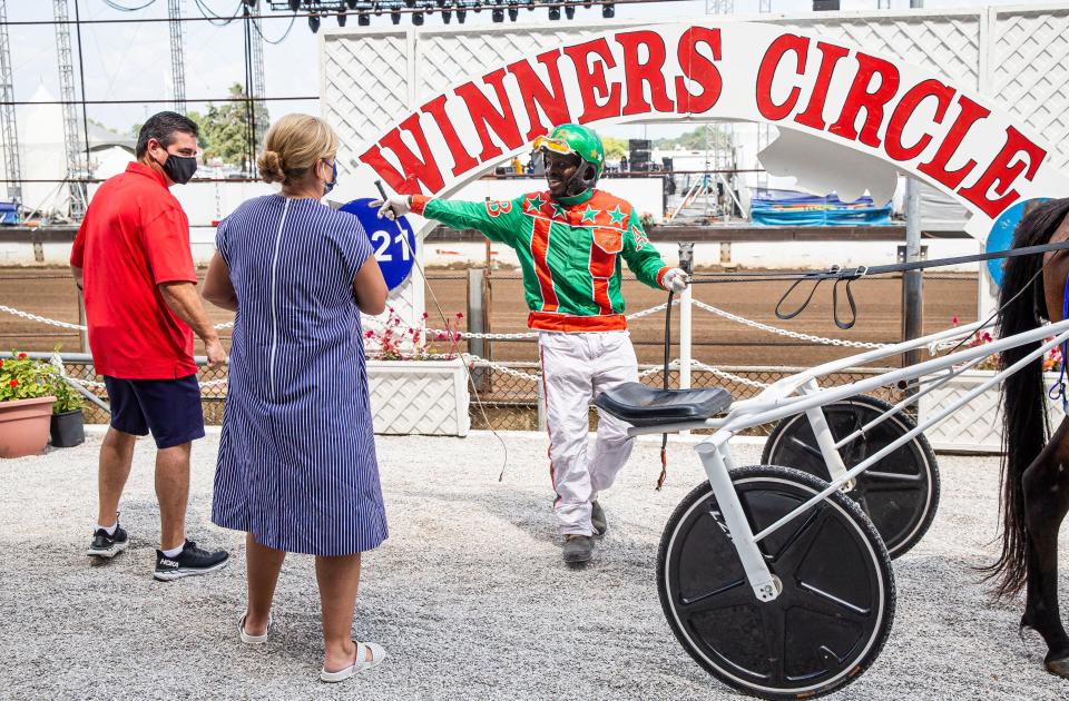 Archie Buford celebrates after being congratulated by Illinois First Lady MK Pritzker after driving Rollnroz to victory in Illinois State Fair Colt Stakes Championship for Two Year Old Fillies at the Illinois State Fairgrounds in Springfield, Ill., Thursday, August 19, 2021. [Justin L. Fowler/The State Journal-Register] 
