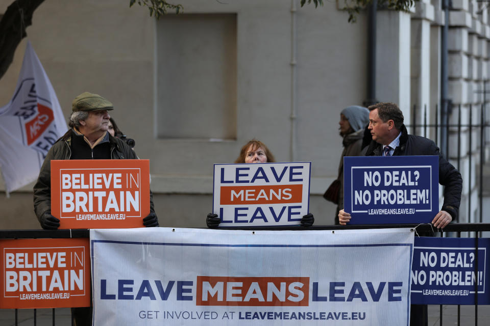 Pro-Brexit demonstrators hold signs outside the Houses of Parliament in London. Photo: Simon Dawson/Reuters