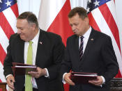 US Secretary of State Mike Pompeo, left, and Poland's Minister of Defence Mariusz Blaszczak after signing the US-Poland Enhanced Defence Cooperation Agreement in the Presidential Palace in Warsaw, Poland, Saturday Aug. 15, 2020. Pompeo is on a five day visit to central Europe. (Janek Skarzynski/Pool via AP)