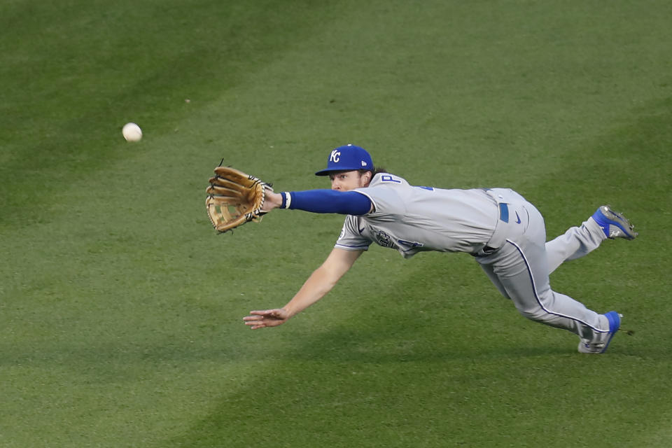 Kansas City Royals' Brett Phillips dives for, but is unable to catch a fly ball from Chicago Cubs' Kris Bryant during the first inning of a baseball game Monday, Aug. 3, 2020, in Chicago. (AP Photo/Charles Rex Arbogast)