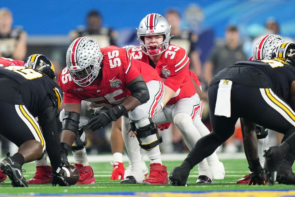 Dec 29, 2023; Arlington, Texas, USA; Ohio State Buckeyes quarterback Devin Brown (33) lines up for a snap behind offensive lineman Matthew Jones (55) during the Goodyear Cotton Bowl Classic against the Missouri Tigers at AT&T Stadium. Ohio State lost 14-3.