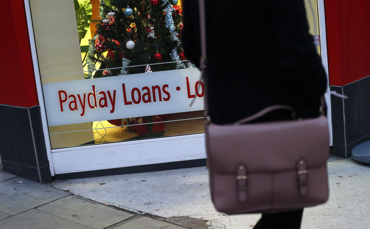 A payday loans sign is seen in the window 