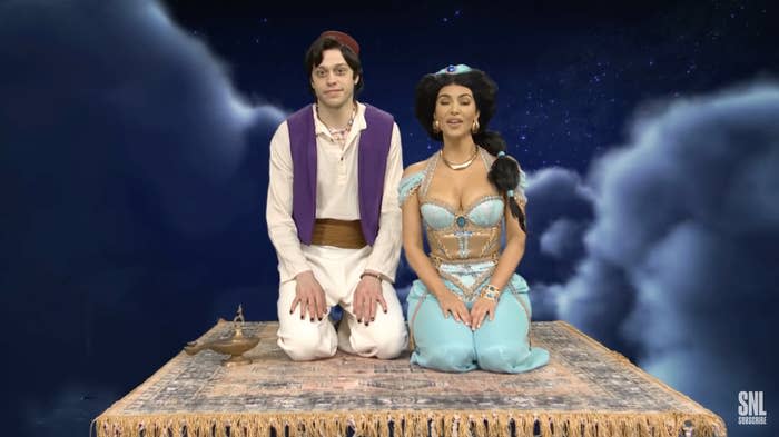 Jasmine and Aladdin sitting on the magical carpet