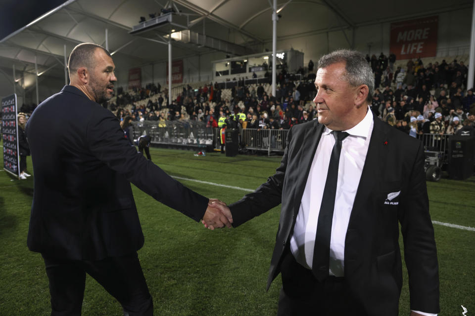 Argentina's head coach Michael Cheika, left, and New Zealand's head coach Ian Foster shake hands after Argentina won their Rugby Championship test match in Christchurch, New Zealand, Saturday, Aug. 27, 2022. (Martin Hunter/Photosport via AP)