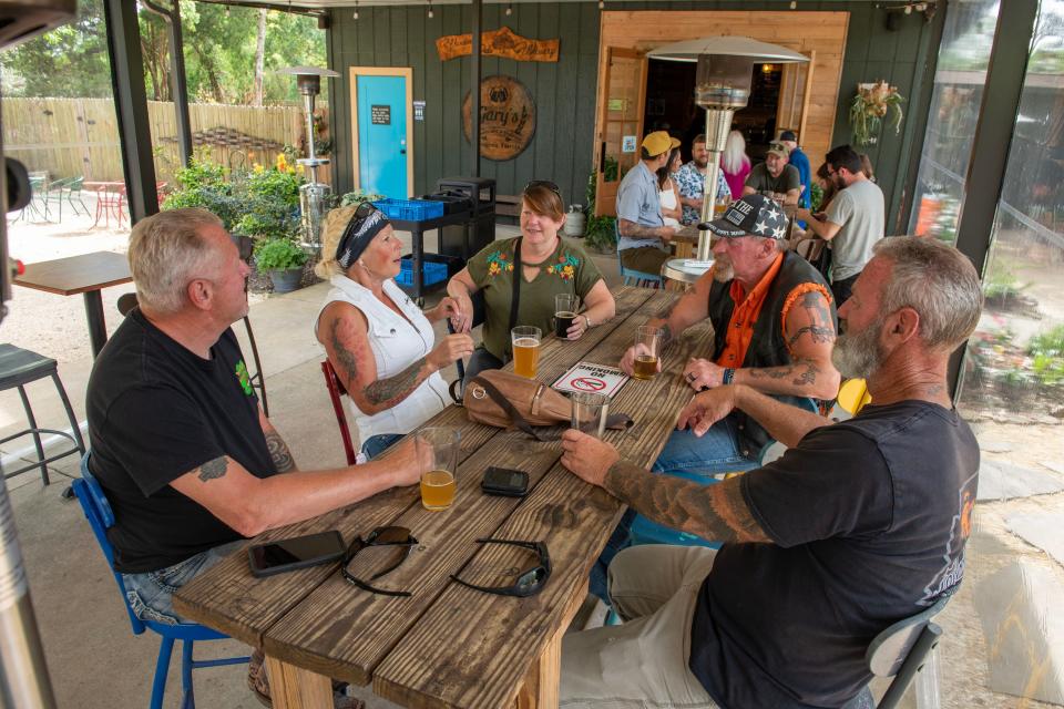 Customers enjoy good company and cold beer at Gary's Brewery and Biergarten Sunday, April 2, 2023.