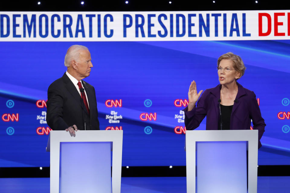 Democratic presidential candidate former Vice President Joe Biden, left, listens as Sen. Elizabeth Warren, D-Mass., speaks during a Democratic presidential primary debate at Otterbein University, on Oct. 15, 2019, in Westerville, Ohio. | John Minchillo—AP