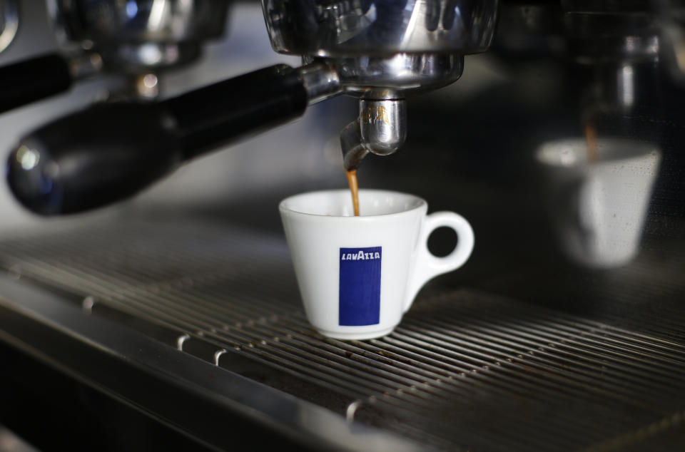 Coffee flows into a Lavazza cup at a coffee shop in Rome