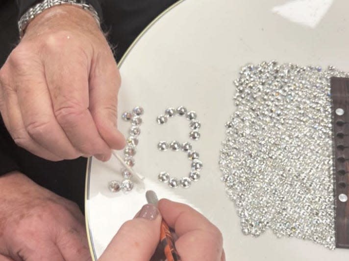 Taylor Swift's parents recreate her sparkly "Fearless" guitar for the Eras Tour.