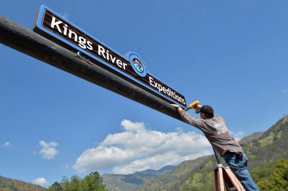 Kings River Expeditions owner Justin Butchert, 56, of Clovis, tightens some bolts on the business sign at Twin Pines Flat base camp on Friday, March 25, 2016 above Pine Flat Reservoir in the Sierra National Forest east of Fresno. Following four straight years of drought, the whitewater rafting company had almost gone out of business and in February, Butchert posted a plea on Facebook to help keep the business open, and their customers responded.