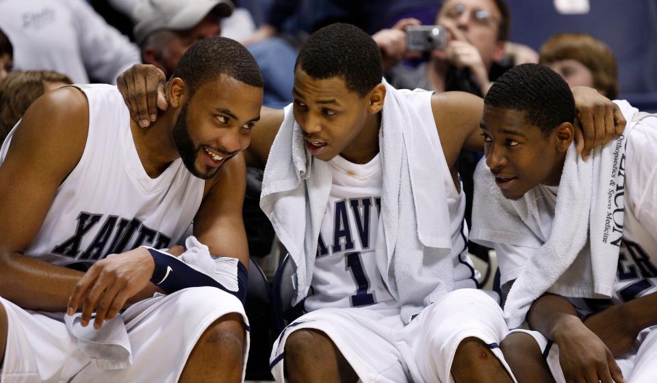 Xavier's (left to right) Jason Love, Mark Lyons and Jordan Crawford get together on the bench in the final minutes of their game against Saint Bonaventure at the Cintas Center Saturday March 6, 2010.