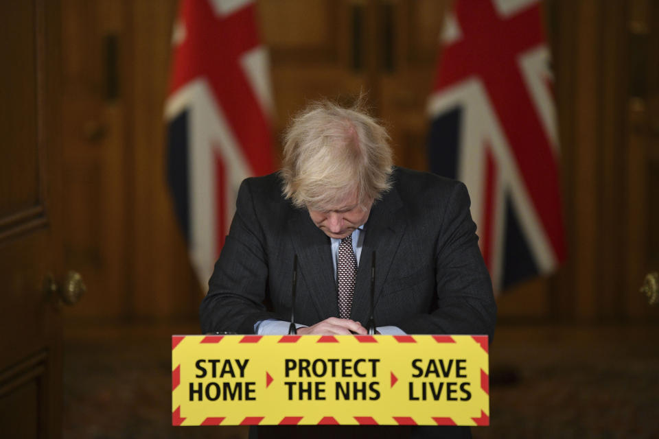 FILE - Britain'sPrime Minister Boris Johnson reacts while leading a virtual news conference on the COVID-19 pandemic, inside 10 Downing Street in central London on Jan. 26, 2021. Former Prime Minister Boris Johnson deliberately misled Parliament about the lockdown-flouting parties that undermined his credibility and contributed to his downfall, a committee of lawmakers said Thursday, June 15, 2023 after a year-long investigation. (Justin Tallis/Pool via AP, File)